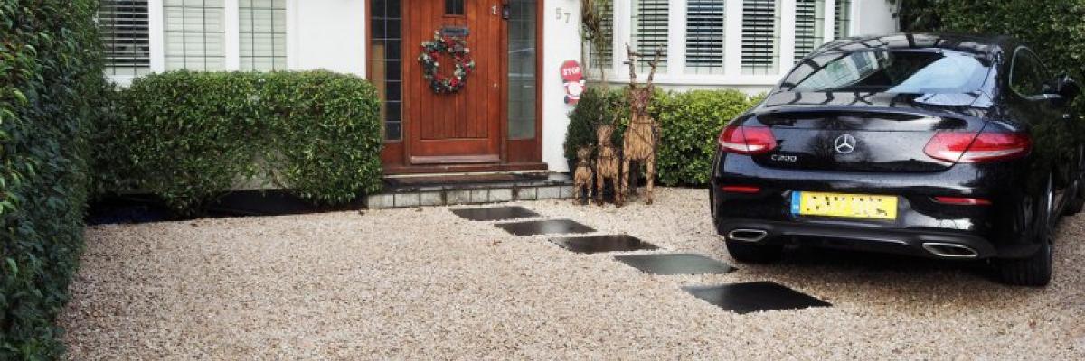 Gravel driveway with stepping stones leading to the front door